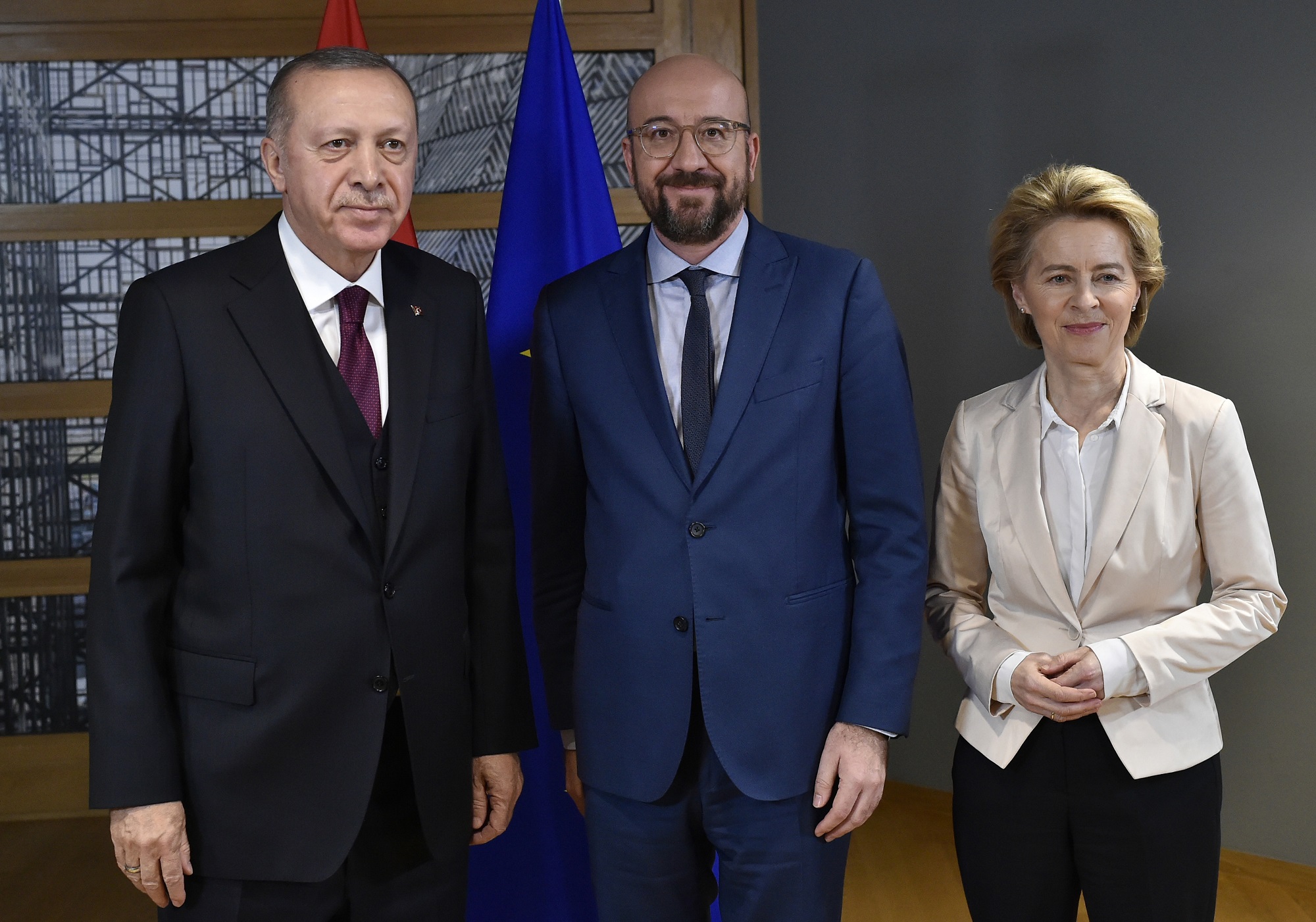 Turkish President Recep Tayyip Erdogan, left, is welcomed by European Council President Charles Michel, center, and European Commission President Ursula von der Leyen at the European Council building in Brussels, Monday, March 9, 2020. Turkish President Recep Tayyip Erdogan visits Brussels on Monday for talks with EU and NATO officials amid a standoff between Ankara and Brussels over sharing of responsibility for refugees and migrants. (John Thys, Pool Photo via AP)