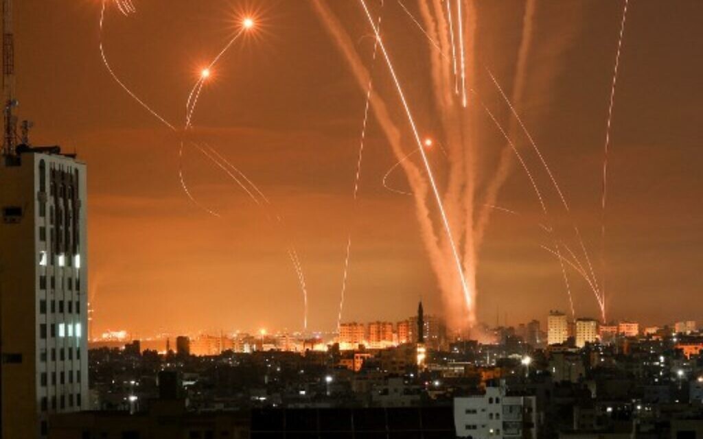 Rockets light up the night sky as they are fired towards Israel from Beit Lahia in the northern Gaza Strip on May 14, 2021. - Israel bombarded Gaza with artillery and air strikes on Friday, May 14, in response to a new barrage of rocket fire from the Hamas-run enclave, but stopped short of a ground offensive in the conflict that has now claimed more than 100 Palestinian lives.
As the violence intensified, Israel said it was carrying out an attack "in the Gaza Strip" although it later clarified there were no boots on the ground. (Photo by MOHAMMED ABED / AFP)