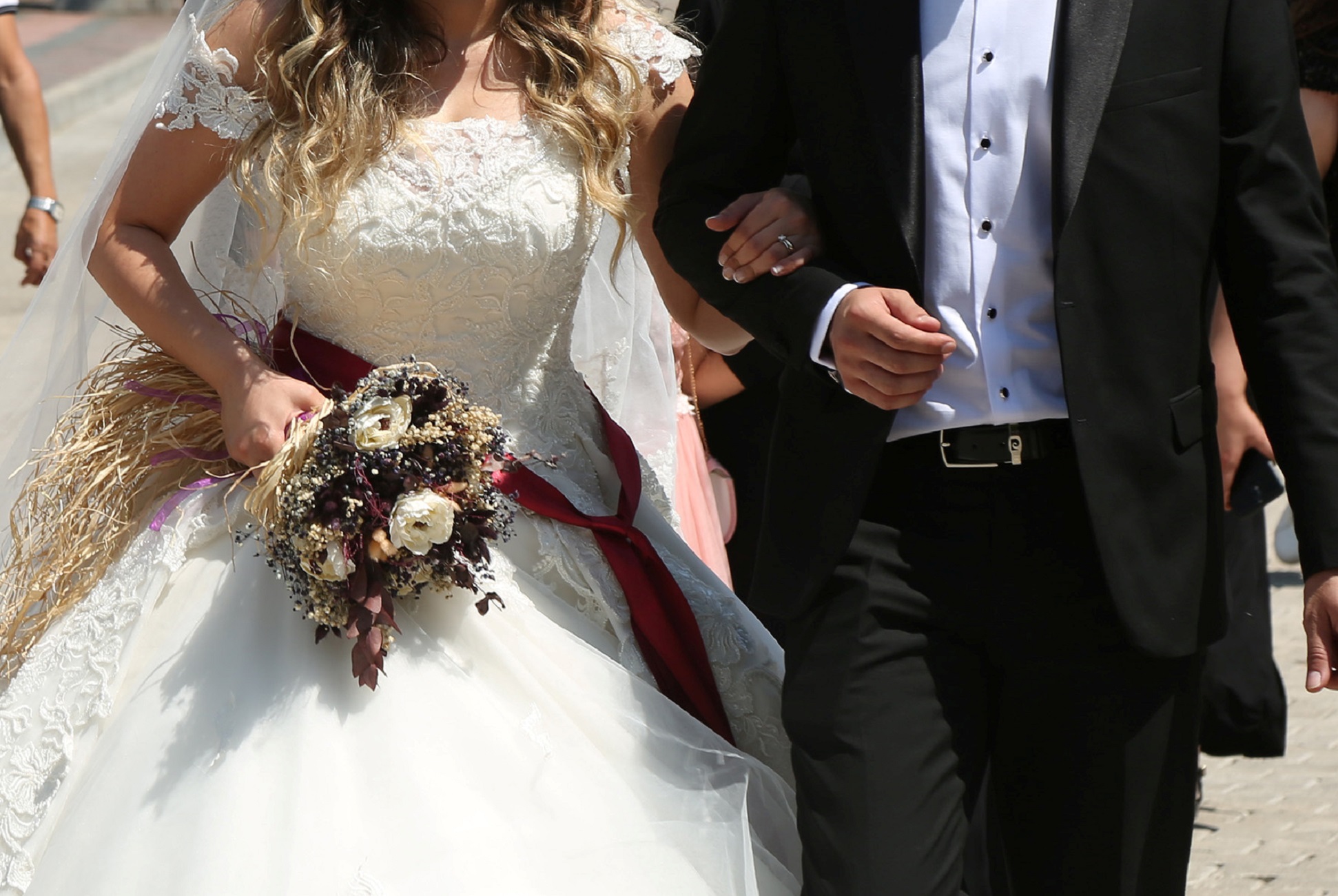 Bride Pelsin Akkoyun and groom Nizamettin Bingol, wearing protective face masks, walk following their civil wedding ceremony, amid the spread of the coronavirus disease (COVID-19), in Diyarbakir, Turkey, July 2, 2020. Turkey reopened its wedding halls in one of the final steps of reopening from the shutdown due to the coronavirus disease (COVID-19). REUTERS/Sertac Kayar