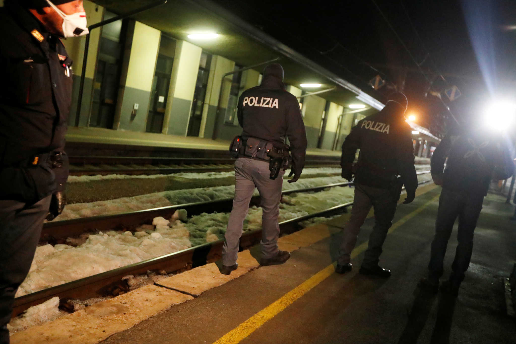 Italian police officers are seen inside the Brennero-Brenner train station in Italy after the train left, February 23, 2020. REUTERS/Leonhard Foeger