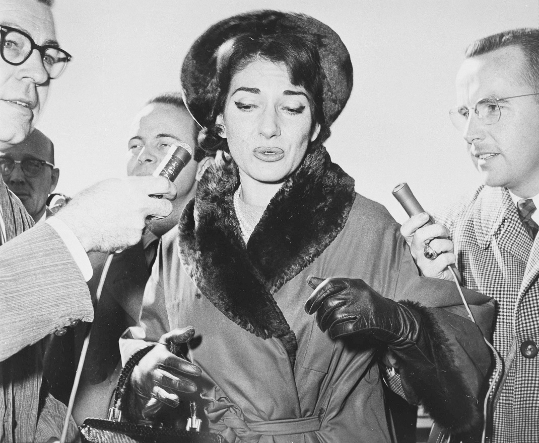Soprano Maria Callas, brushes newsmen aside as she arrives in Dallas, Texas, where she will appear in the opera "Medea", Nov. 18, 1959. The temperamental star interrupted her engagement in Dallas to appear in Italy at a hearing of a separation suit brought by her husband, Italian industrialist Giovanni Meneghini. (AP Photo/Carl E. Linde)