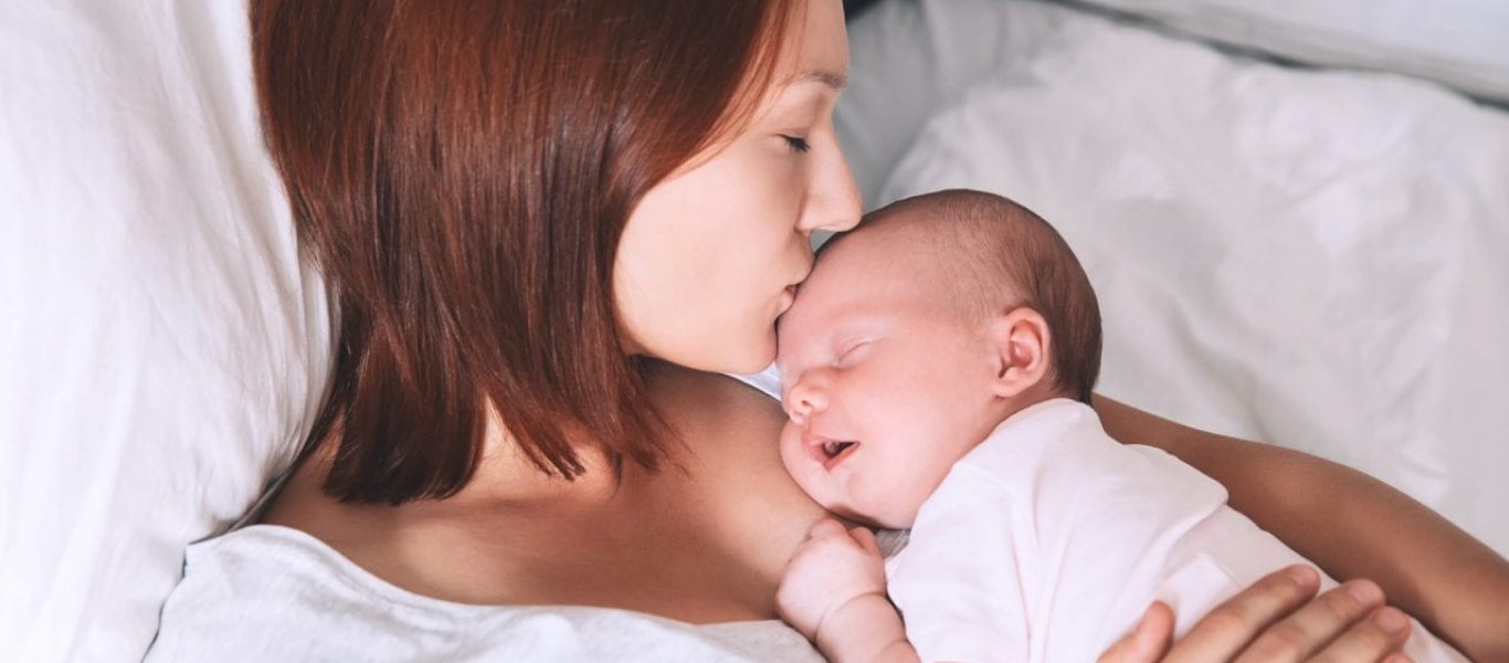 mother-kissing-newborn-baby-1280x700