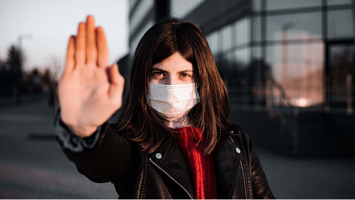 Young girl shows hand sign stop no to coronavirus epidemic pandemia originated at China. Covid-19 virus, nCov2019. Girl is against using public transport and stay home during quarantine
