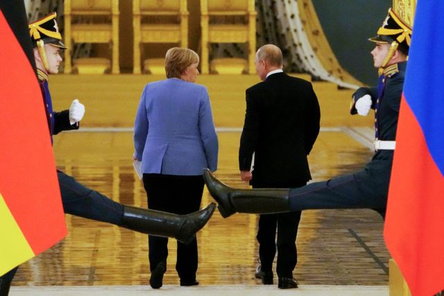 Russian President Vladimir Putin and German Chancellor Angela Merkel leave after a news conference following their talks at the Kremlin in Moscow, Russia August 20, 2021. Alexander Zemlianichenko/Pool via REUTERS