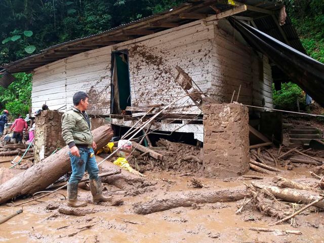 A man stands next to a destroyed building in the area affected by a flash flood that flooded a gold mine and killed people, in Abriaqui, Colombia April 8, 2022. Courtesy of Goverment of Antioquia/Handout via REUTERS ATTENTION EDITORS - THIS IMAGE WAS PROVIDED BY A THIRD PARTY. MANDATORY CREDIT