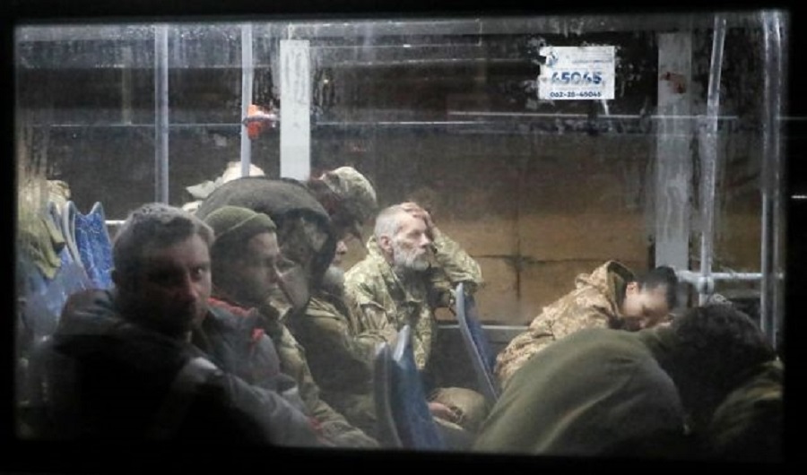 Service members of the Ukrainian armed forces, who surrendered at the besieged Azovstal steel mill in Mariupol in the course of Ukraine-Russia conflict, sit in a bus upon their arrival under escort of the pro-Russian military in the settlement of Olenivka in the Donetsk region, Ukraine May 20, 2022. REUTERS/Alexander Ermochenko