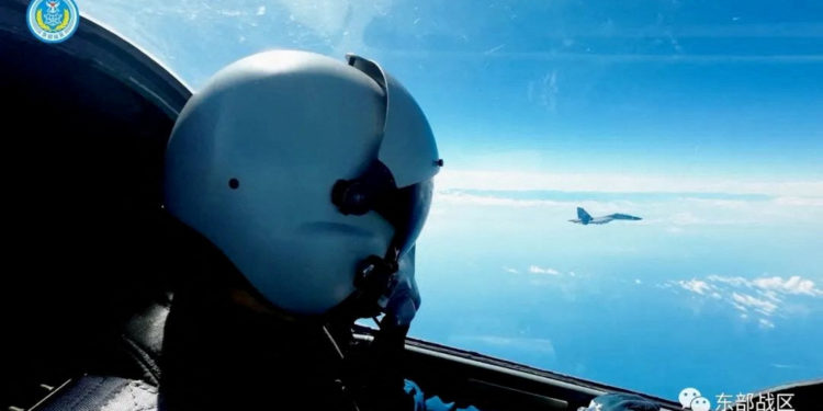 An Air Force pilot navigates an aircraft next to a fighter jet under the Eastern Theatre Command of China's People's Liberation Army (PLA) during military exercises in the waters and airspace around Taiwan, at an undisclosed location August 9, 2022 in this handout image released on August 10, 2022. Eastern Theatre Command/Handout via REUTERS ATTENTION EDITORS - THIS IMAGE WAS PROVIDED BY A THIRD PARTY. MANDATORY CREDIT. NO RESALES.