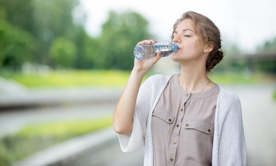 bigstock-Young-Woman-Drinking-Water-Fro-134983244