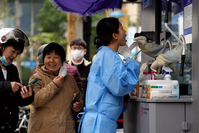 A woman gets swabbed to be tested for the coronavirus disease (COVID-19) at a nucleic acid testing site in Shanghai, China December 7, 2022. REUTERS/Aly Song
