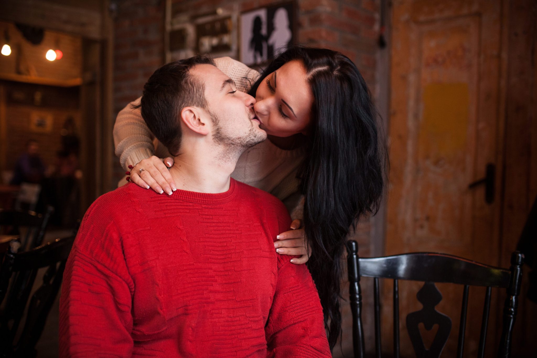 girl-kissing-man-cafe-scaled-1-2048x1366