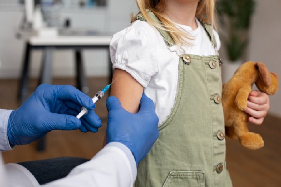 male-pediatrician-administering-vaccine-his-office-