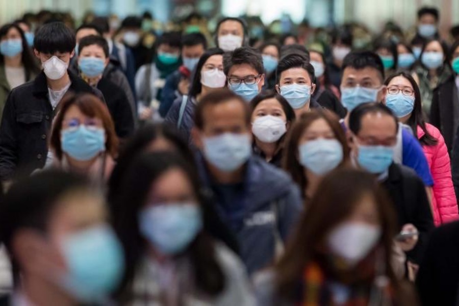 Commuters wearing protective masks walk through Hong Kong Station, operated by MTR Corp., in Hong Kong, China, on Wednesday, Jan. 29, 2020. Governments tightened international travel and border crossings with China as they ramped up efforts to stop the spread of the disease. Photographer: Paul Yeung/Bloomberg via Getty Images