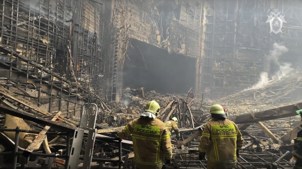 In this photo taken from video released by the Investigative Committee of Russia on Saturday, March 23, 2024, firefighter work in the burned concert hall after an attack on the building of the Crocus City Hall on the western edge of Moscow, Russia. Russia's top state investigative agency says the death toll in the Moscow concert hall attack has risen to  over 130. The attack Friday on Crocus City Hall, a sprawling mall and concert venue on Moscow's western edge, also left many wounded and left the building a smoldering ruin. (Investigative Committee of Russia via AP)