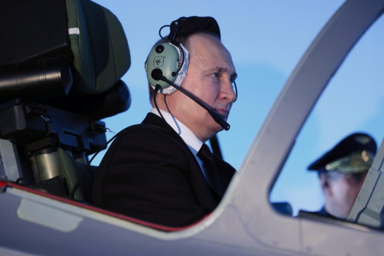 Putin-on-aircraft-EPA-Sputnik-pool-