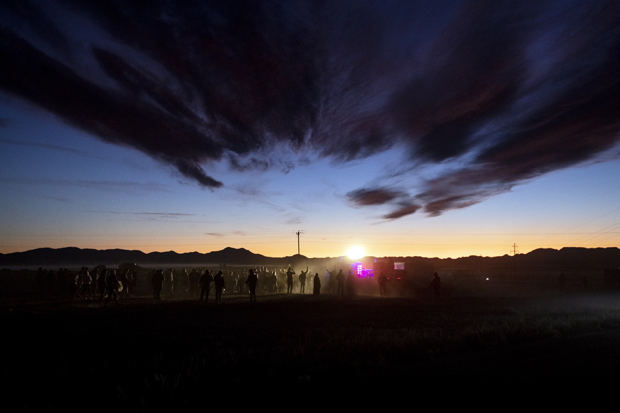 epaselect epa07857976 People dance during a DJ set at 'Alienstock' in Rachel, Nevada, USA, 20 September 2019. Starting as a joke, the 'Storm Area 51' event transformed into a gathering for alien believers, with music and attractions held in several places around Area 51.  EPA/ETIENNE LAURENT