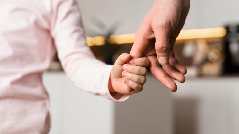 little-girl-holding-hands-with-father-