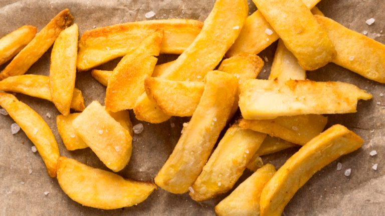 top-view-french-fries-paper-with-salt-
